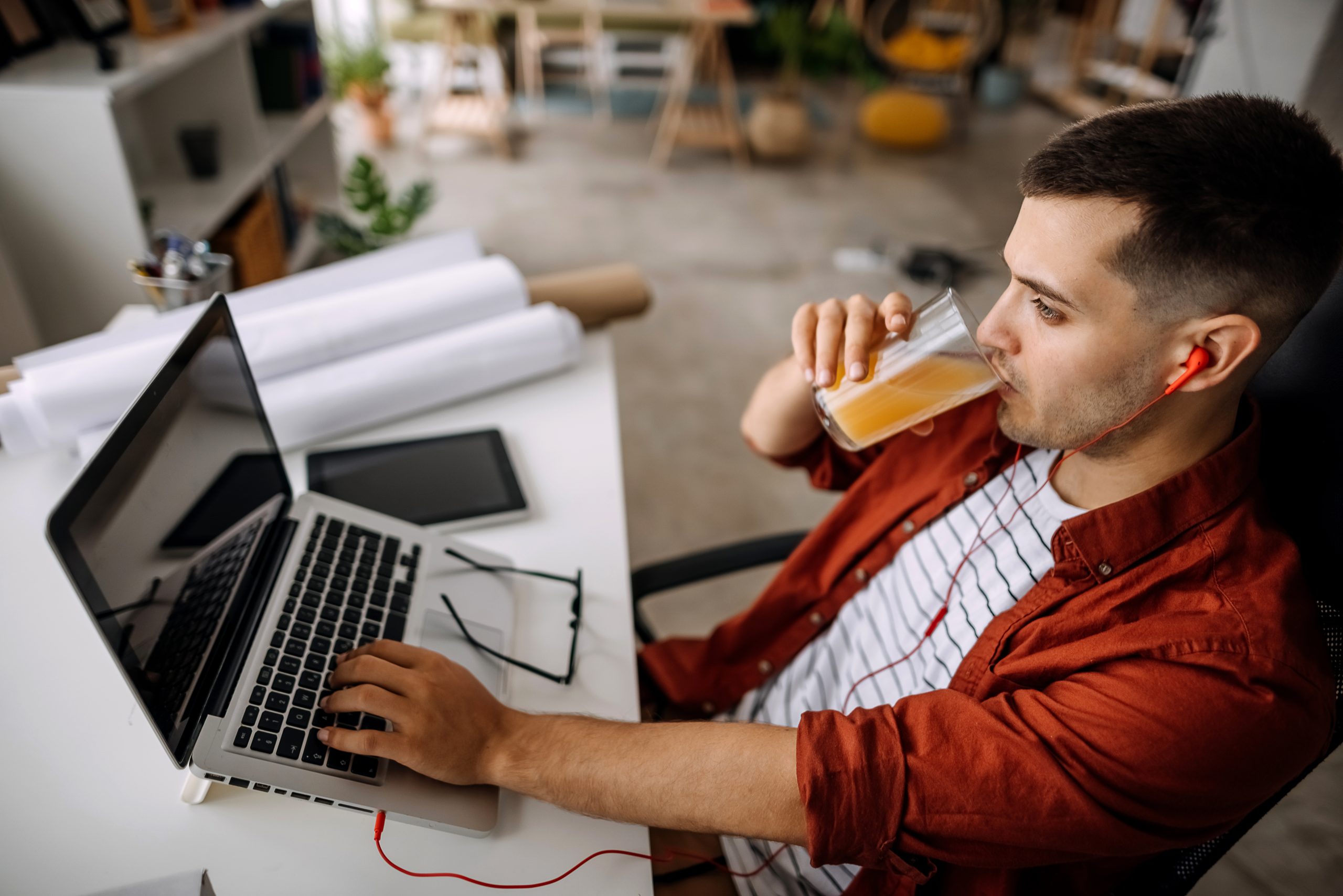 Man works in an office on a laptop