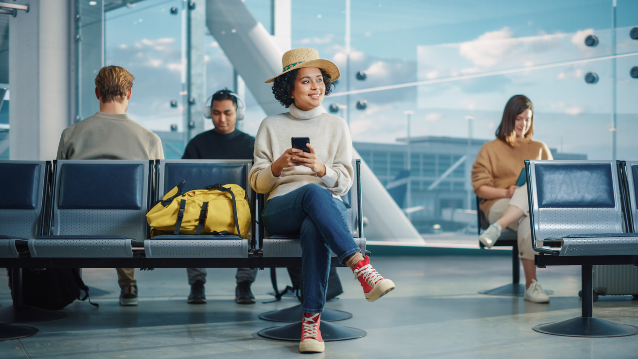 Airport Terminal: Diverse Multi-Ethnic Crowd of People Wait for